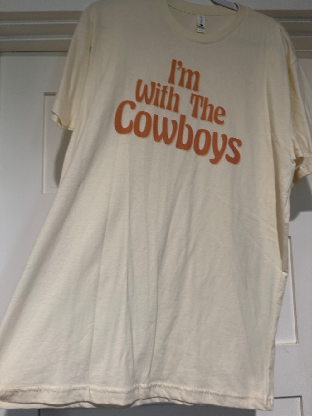Bella Canvas Cream Tee with Orange 'I'm With The Cowboys' Graphic